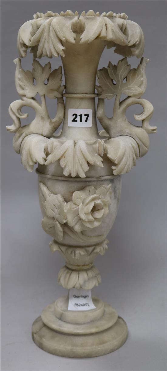 A Victorian carved alabaster two handled vase, encrusted with flowers and leaves 42cm.